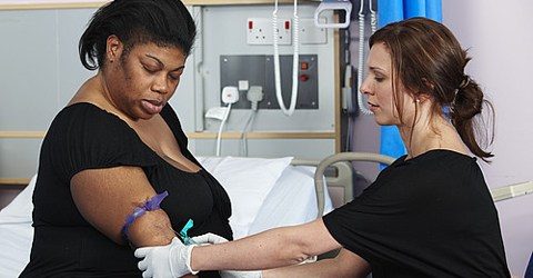person getting blood pressure checked by nurse in hospital setting