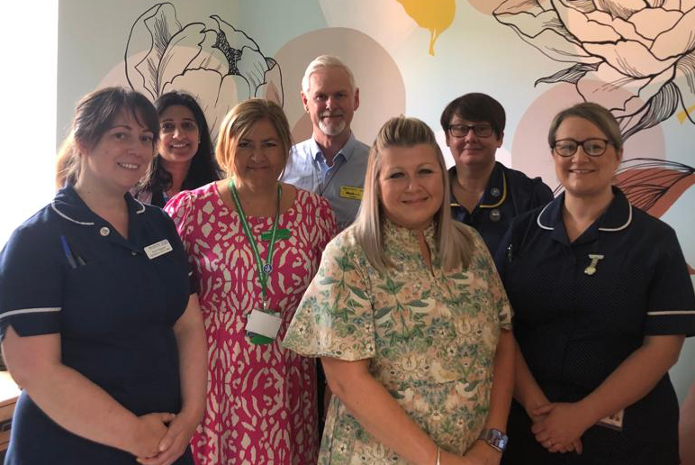 Members of the Palliative and End of Life Care team stood together in a new family room.