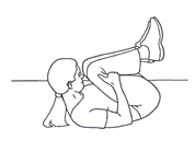 Person is rolled into tuck position on floor knees into chest and head and shoulders raised 