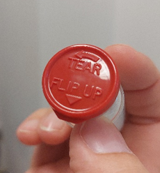 Vial of medicine with top closed saying tear and flip up 