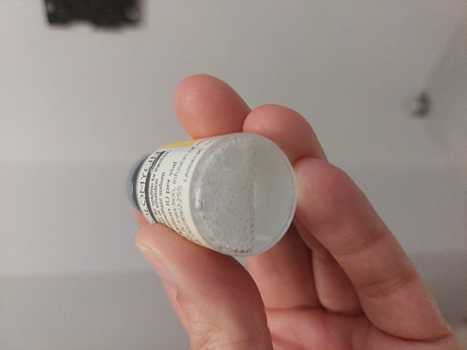 Bottom of vial showing foam from being shaken too vigorously