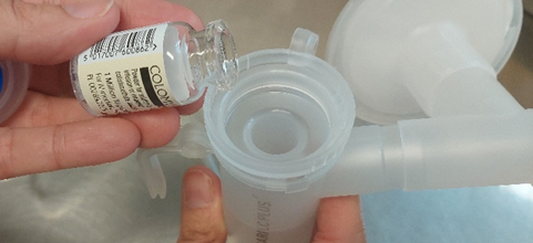 Vial contents being poured into nebuliser medicine chamber