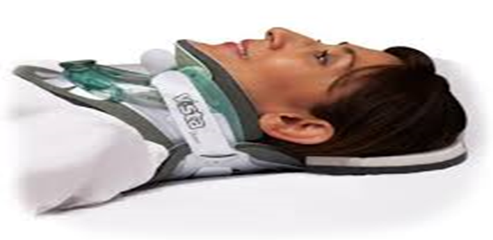 Person lying on back with neck collar supported by back panel
