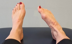Feet on bed, toes pointing up, ankle flexed inward