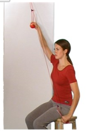 Person using pulley system to move arms up and down back is side on to wall