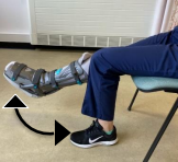 Demonstrates leg exercise sitting on chair lift injured leg and straighten knee