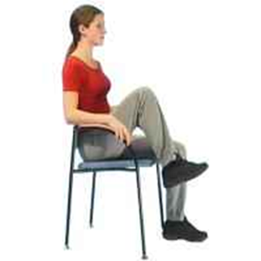 Person sitting tall in a chair raising alternate legs