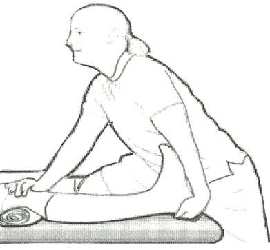 A helper is aiding an individual to stretch by pushing knee down into a rolled up towel whilst pulling on heel
