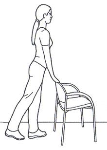 Person holding chair back extending straight leg to rear