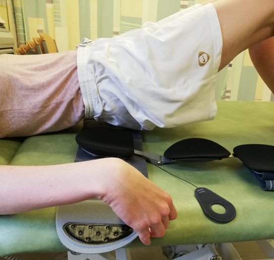 Person lifting bottom to slide brace underneath lower back