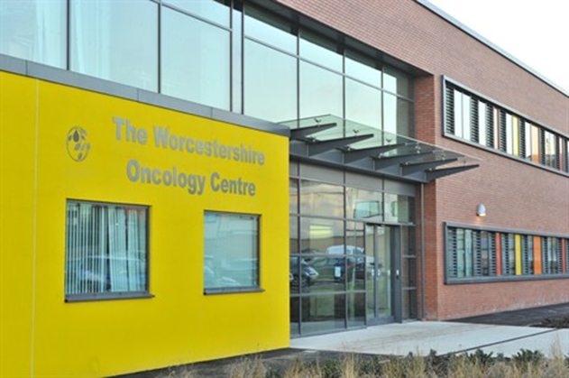 A photographic image of the outside of Worcestershire Oncology Centre at Worcester Royal Hospital showing the entrance an yellow exterior