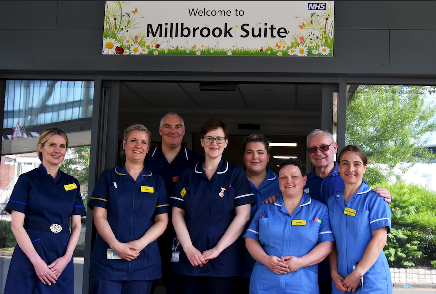 Members of the Millbrook Suite team outside their new home.