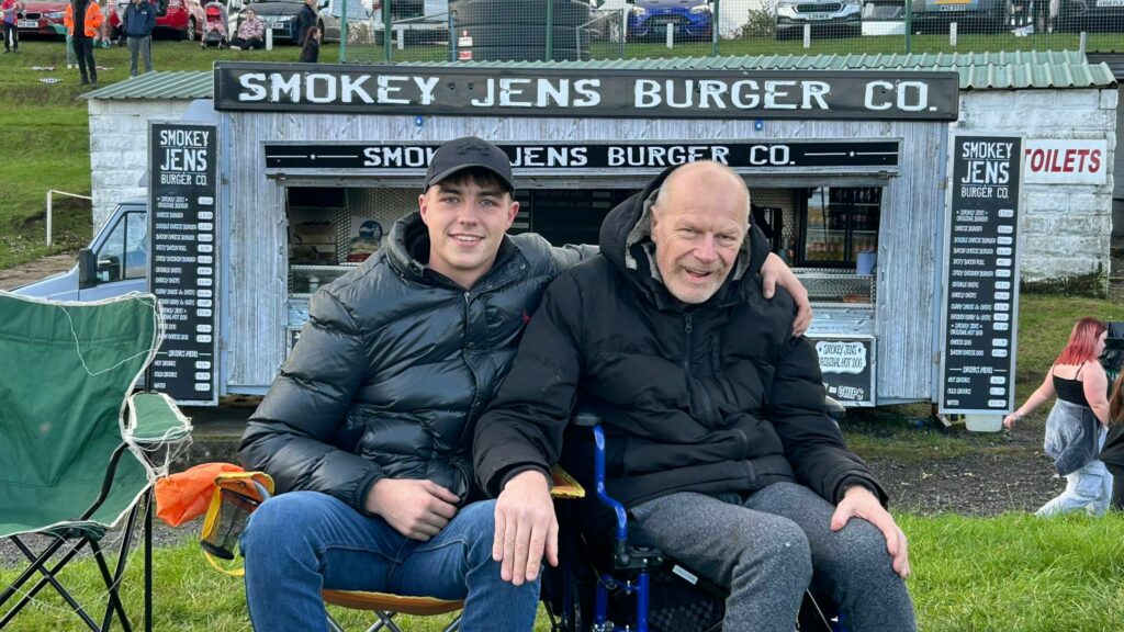 Sean sat outside with his son at an event recently.