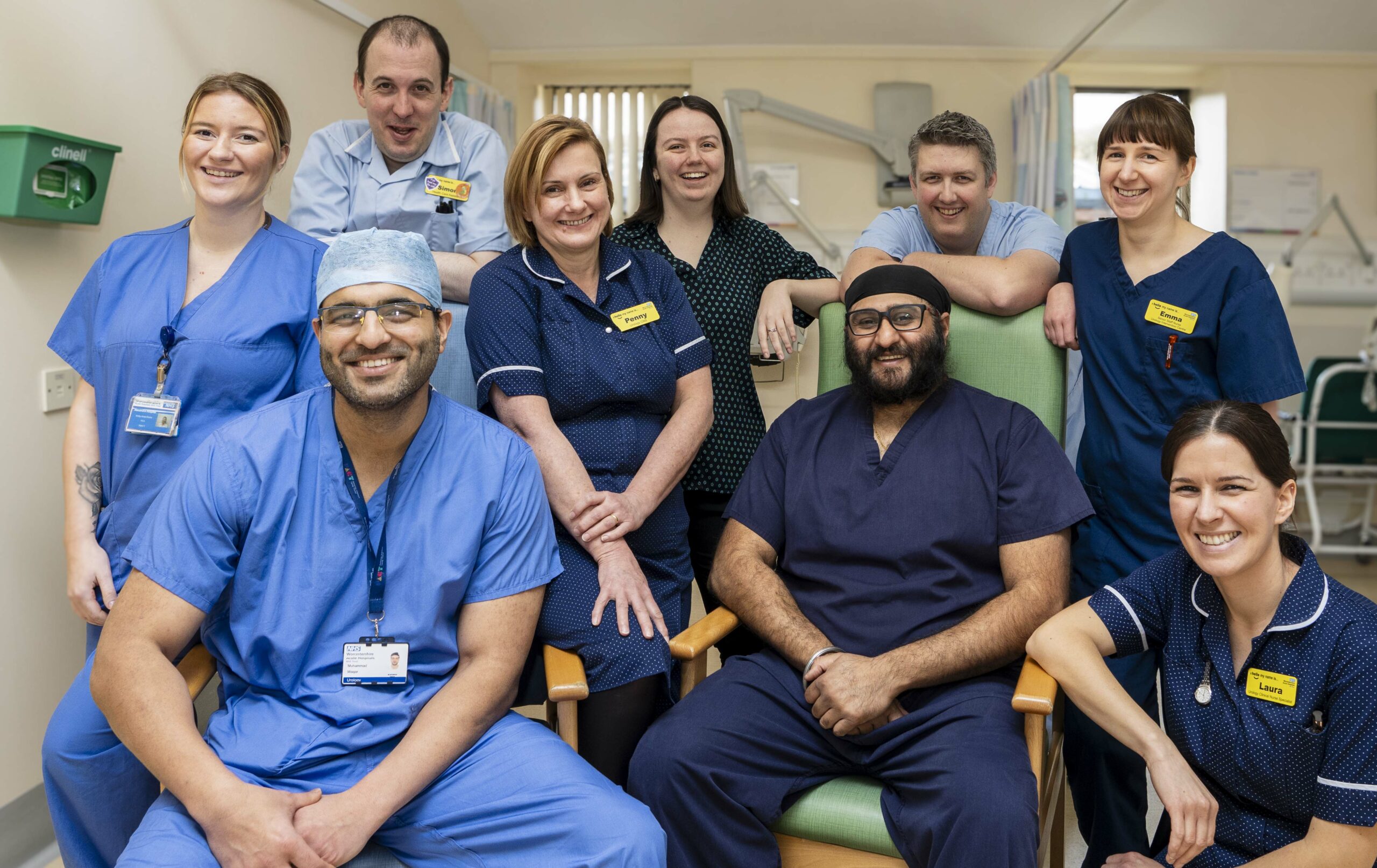 Ward staff from the Urology Department at the Alexandra Hospital sad or stood together, smiling at the camera.