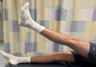 A person lying on their back and raising one leg in the air.