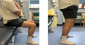 A person sitting down and standing up without using their arms.