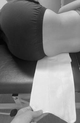 Image of person on side with abdominal binder tucked under lower abdomnen