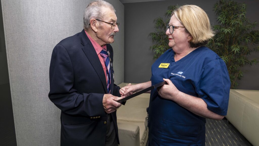 Fred Holland presenting Endoscopy Unit Manager, Deborah Hathaway with the team’s British Citizen Award certificate.
