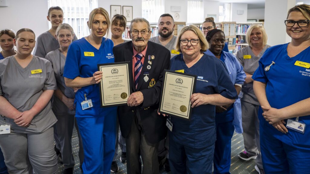 The Kidderminster Hospital Endoscopy team with holding their British Citizen Award certificates, stood with Fred Holland.