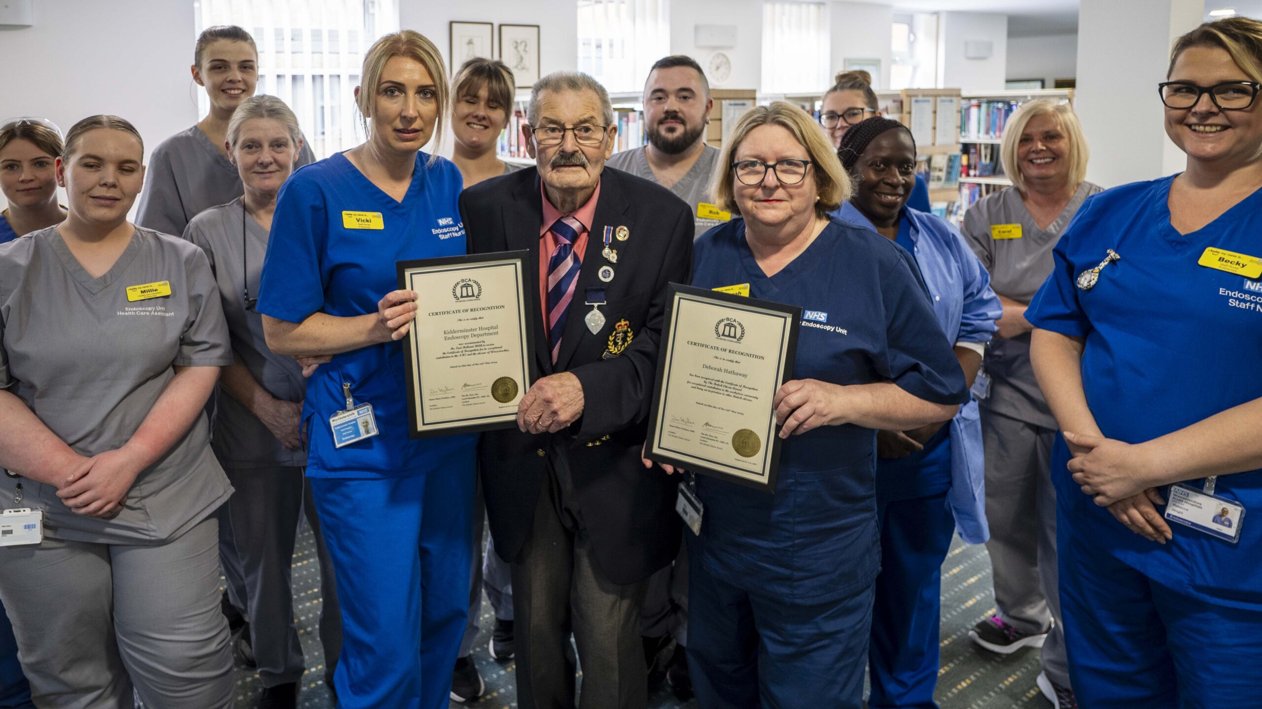 The Kidderminster Hospital Endoscopy team with holding their British Citizen Award certificates, stood with Fred Holland.