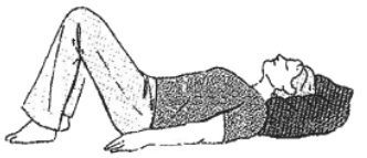 Person lay flat on back, head supported by a pillow, knees bent