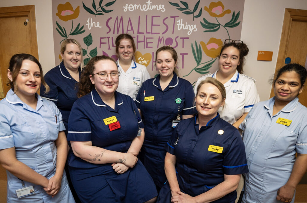 Team photo of ward staff on the postnatal ward stood together,