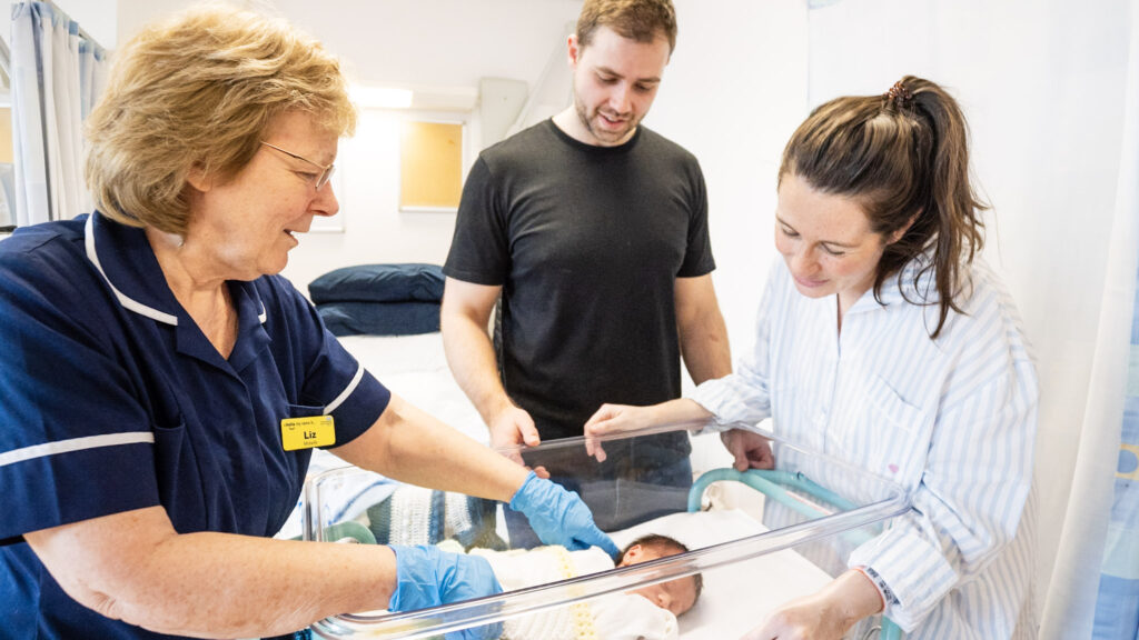 Baby check observations with the mother and father looking on