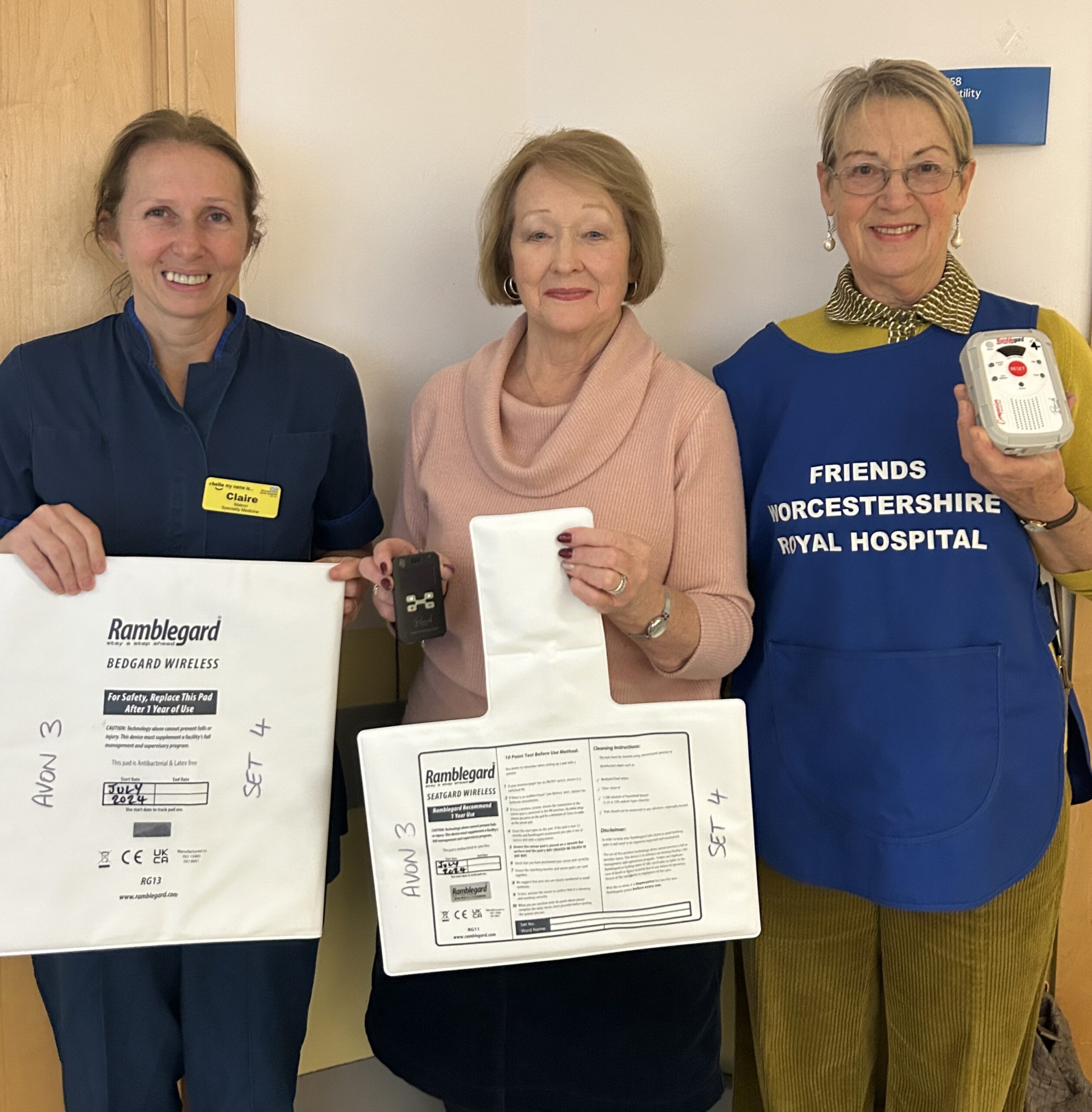 Members of The Friends of Worcestershire Royal Hospital with Claire James holding the Ramblegard Fall Alarm.