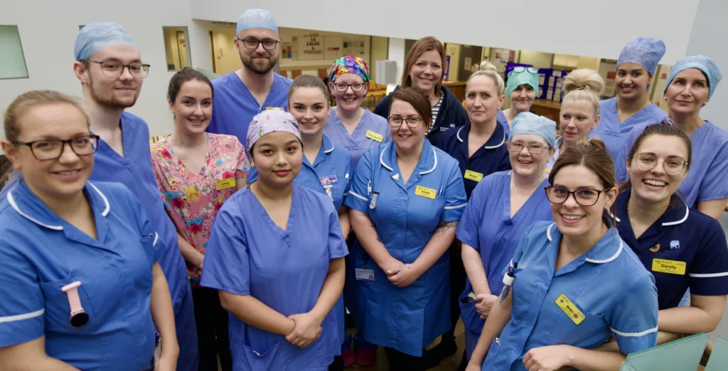 A range of clinical staff in uniform stand together at Kidderminster Treatment Centre to celebrate.