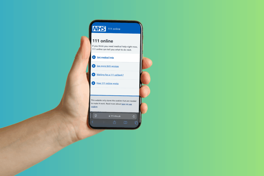 Hand holding a phone showing the NHS111 online website
