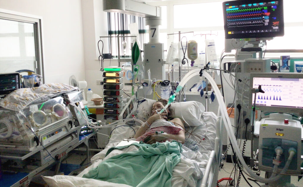 Helen holding Maeve on ventilation in Intensive Care.