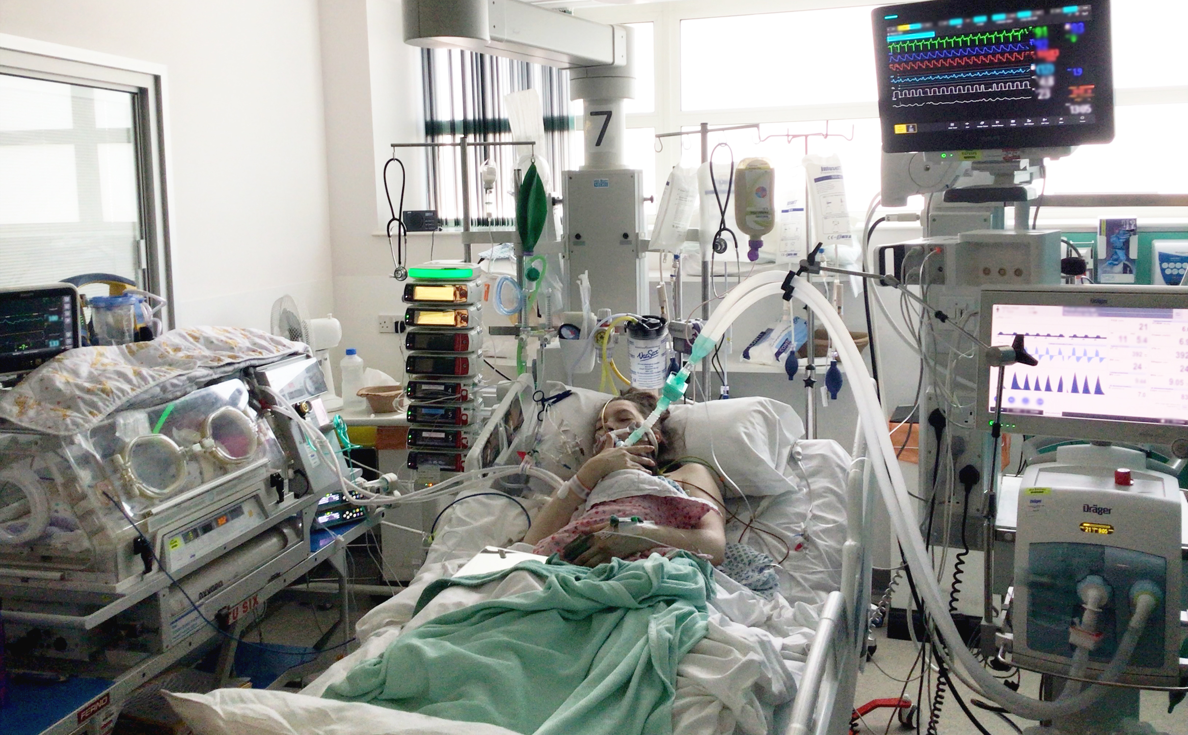 Helen holding Maeve on ventilation in Intensive Care.