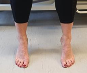 Feet with heels raised off floor