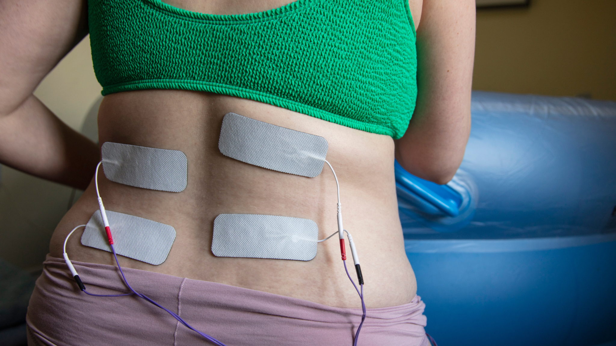 A Pregnant Woman In Labour Wearing A Tens Machine