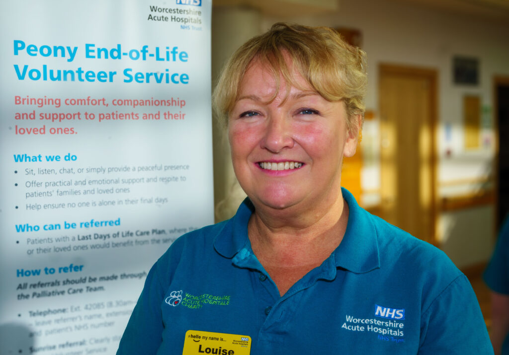 Peony Volunteer, Louise Carter stood in the main entrance at Worcestershire Royal Hospital