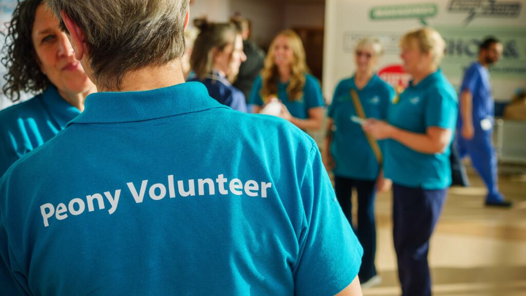 Volunteers at the launch of the service. One is wearing a t shirt with 'Peony Volunteer' printed on the back