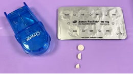 Tray with equipment to administer pills including the pills, blister pack and pill cutter. The pill is shown whole, halved and quartered