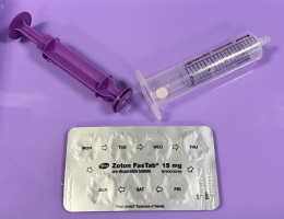 Syringe with plunger removed and pill placed in tube (also shows blister pack)