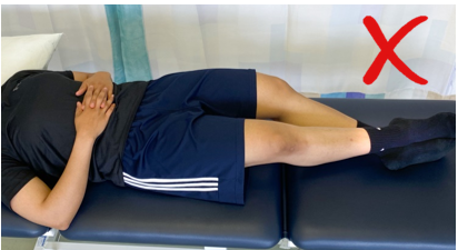A do not image with a red cross showing an individual lay on back with knees unsupported 