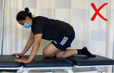 A do not image with a red cross showing an individual on all fours with legs crossed