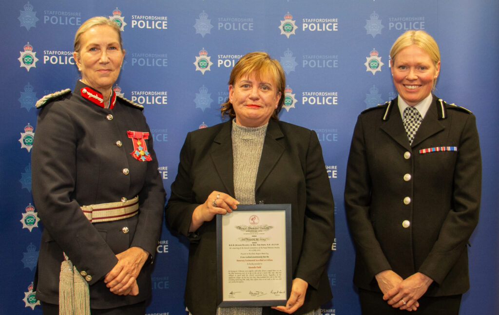 Amanda stood (centre) receiving her award from Staffordshire Police's Deputy Chief Constable, Caroline Marsh (right) and the Lord-Lieutenant of Staffordshire, Liz Barnes (left).