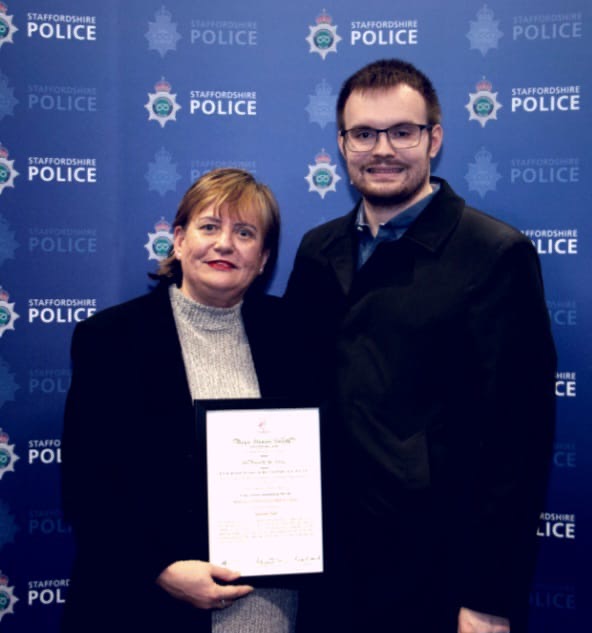 Amanda stood alongside her son holding her certificate after receiving her award at Staffordshire Police HQ.