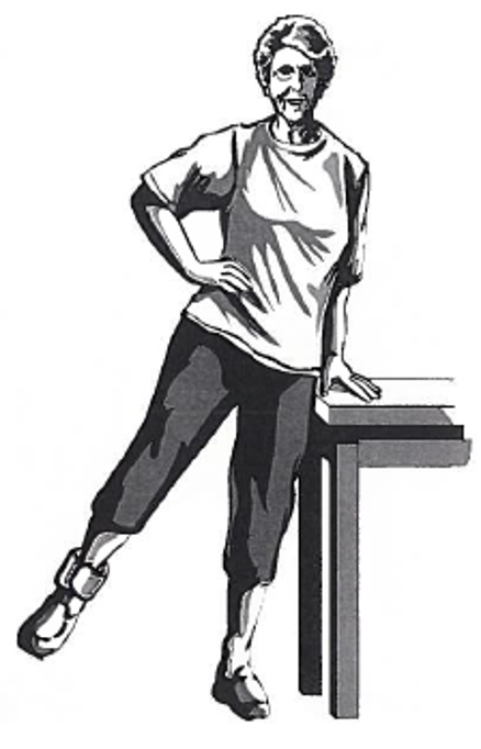 Picture of person holding onto a surface with one hand while raising the leg to the side
