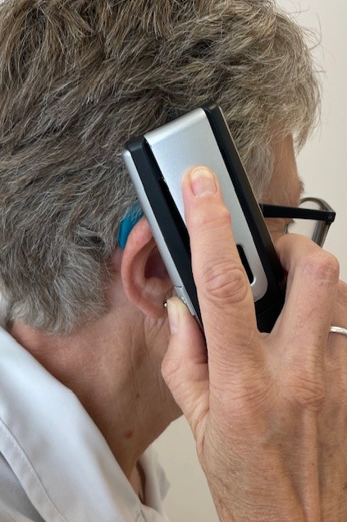 A person holding a phone to her ear