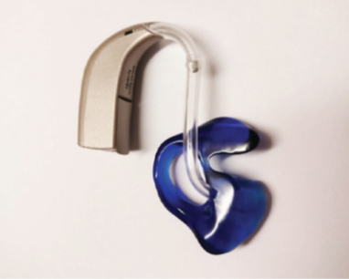 A photograph of the mould reattached to the hearing aid