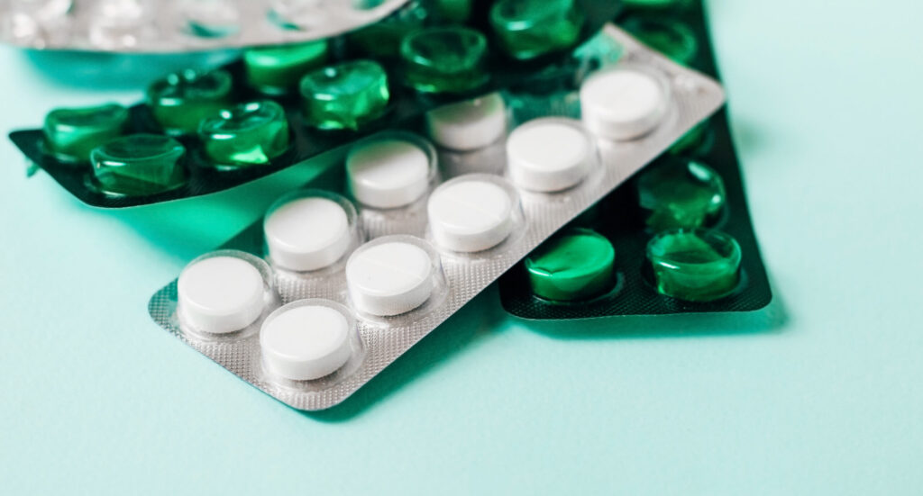Strips of pain medication tablets on a table.