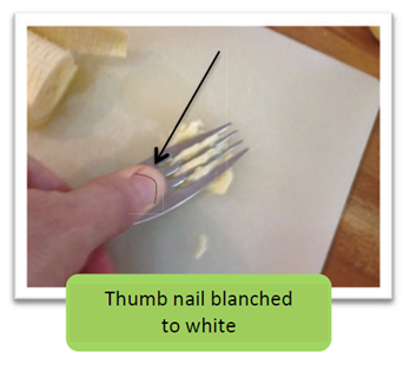 A photograph of a person using a fork, pressing down on the food