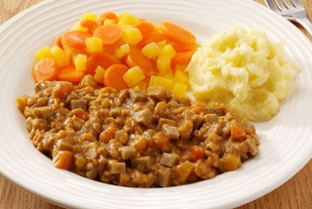 A photograph of a plate with food in small pieces